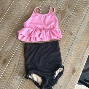 Kortni Jeane black swim bottoms and pink swim top